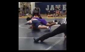 wrestling ref slides across mat